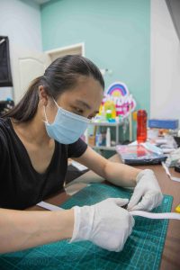 Volunteer making face shields for frontliners